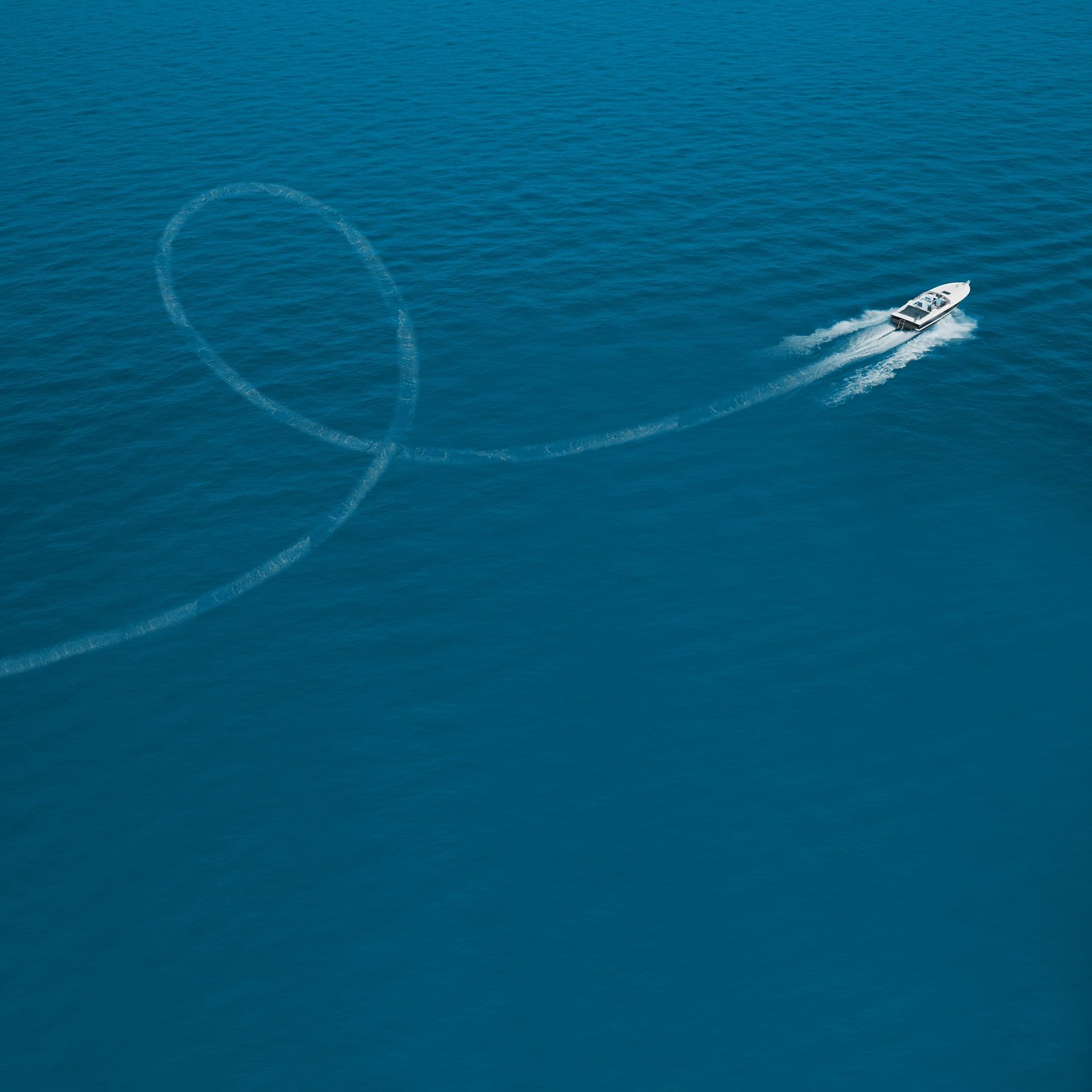 Aerial view luxury motor boat. Drone view of a boat  the blue clear waters. Travel - image. Large speed boat moving at high speed side view.